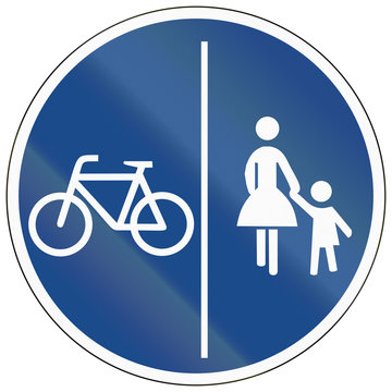 German traffic sign on a shared-use path with separate lanes, left lane for bicycles and right lane for pedestrians