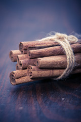 Bunch of cinnamon sticks on stones board