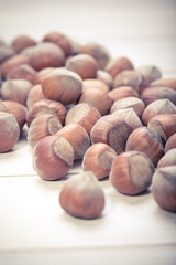 Hazelnuts on old wooden background