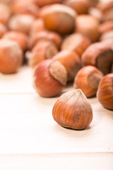Hazelnuts on old wooden background