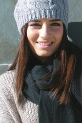 Portrait of young beautiful woman smiling with winter clothes