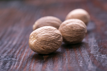 Ground nutmeg spice on the wooden background