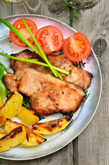 Roasted steaks with baked potatoes