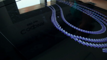 Woman sliding with her fingers over the tourism touch screen