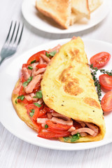 Scrambled eggs with bacon and vegetables