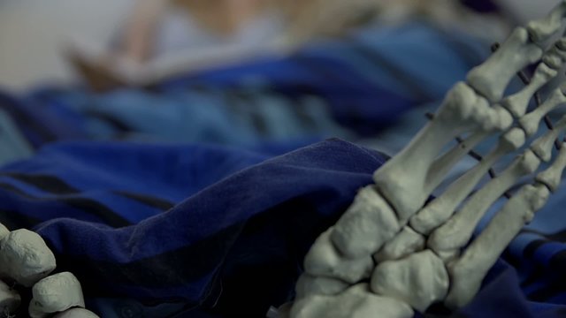 Skeleton feet in the bed