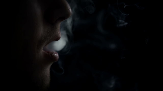 Detail of long exhailing of cigarette smoke