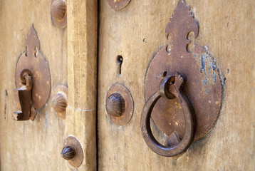 Vintage men's and women's door handles in Yazd, Iran.