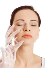 Young woman having cosmetic botox injection