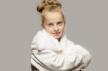 Girl wearing a white long coat, looking like snow white