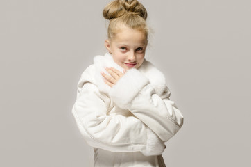 Girl wearing a white long coat, looking like snow white