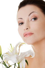 Sensual portrait of a woman with lily flower