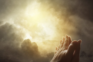 Hands together and bright heavenly sky. Religious prayer © Stillfx