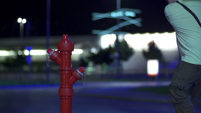 Man destroying the hydrant prop with a golf stick in slow motion