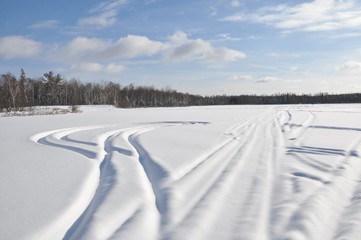 Marks of snowmobile paths in the frozen lake