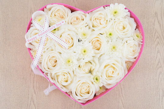 White roses and pearl and diamond held in the heart shape box