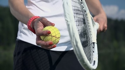 Preparing for tennis serve in slow motion close up