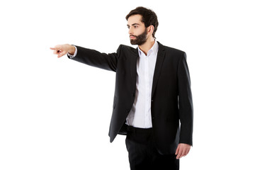 Happy businessman points his finger.