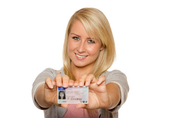 Young woman showing her driver's license - 77406235