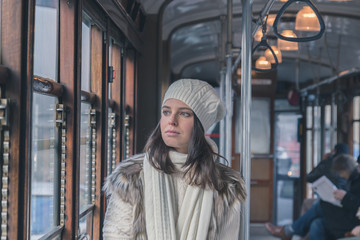 Obraz na płótnie Canvas Beautiful young woman posing on a tram