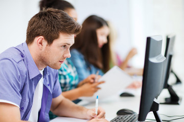 student with computer studying at school © Syda Productions