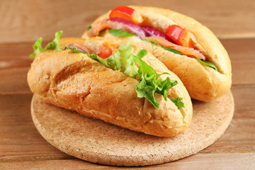 Sandwiches with salmon on wooden background