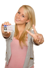 Young woman showing her driver's license - 77407203