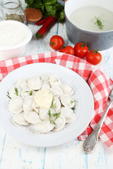 Meat dumplings with sauce on plate on table close-up