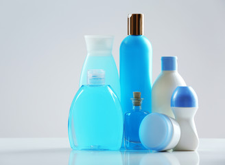 Cosmetic bottles on light background