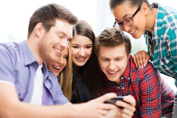 students looking at smartphone at school