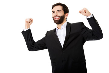 Businessman making fists in a winner gesture.