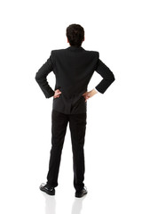 Businessman with hands on hips.