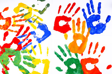 Hand prints of paint on white background