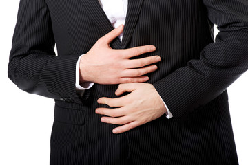 Businessman suffering from stomach pain.