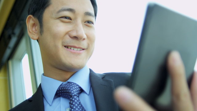Male Asian Chinese Stock Broker Tablet Close Up