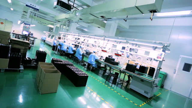 Workers producing PCBs on modern factory assembly line, China