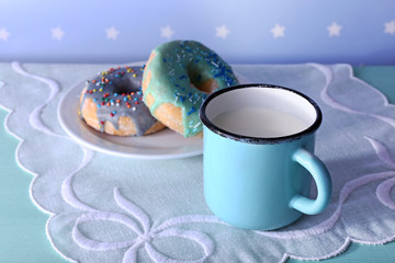 Glazed donuts with cup of milk
