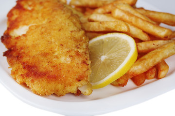 Breaded fried fish fillet and potatoes with sliced lemon