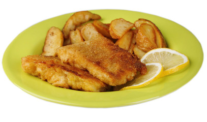 Breaded fried fish fillet and potatoes with sliced lemon