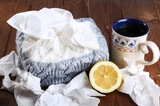 Hot tea for colds and handkerchiefs on table close-up