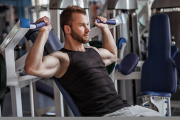 young man in sport gym club - 77414412