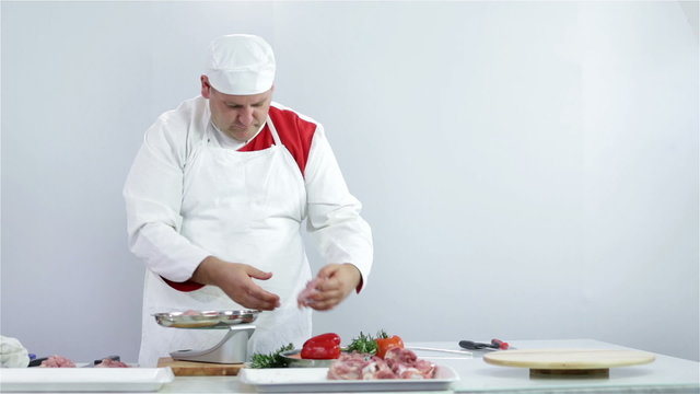 Butcher weighing turkey steaks for customer