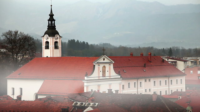 Still shot of church with morning mist in Kamnik,  Slovenia