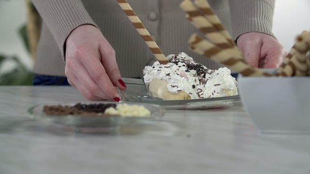 Woman takes the plate with a scoop of ice cream