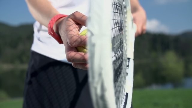 Ball and racket tapping in slow motion close up