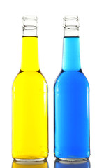 Colorful alcoholic beverages in glass bottles isolated on white