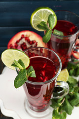 Pomegranate drink in glasses with mint and slices of lime