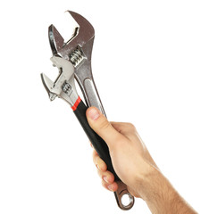 Adjustable wrenches in male hand isolated on white