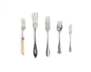 A set of vintage dinnerware: forks of different shapes and sizes