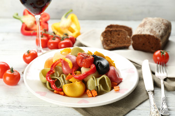 Tasty multicolor pasta with pepper, carrot and tomatoes